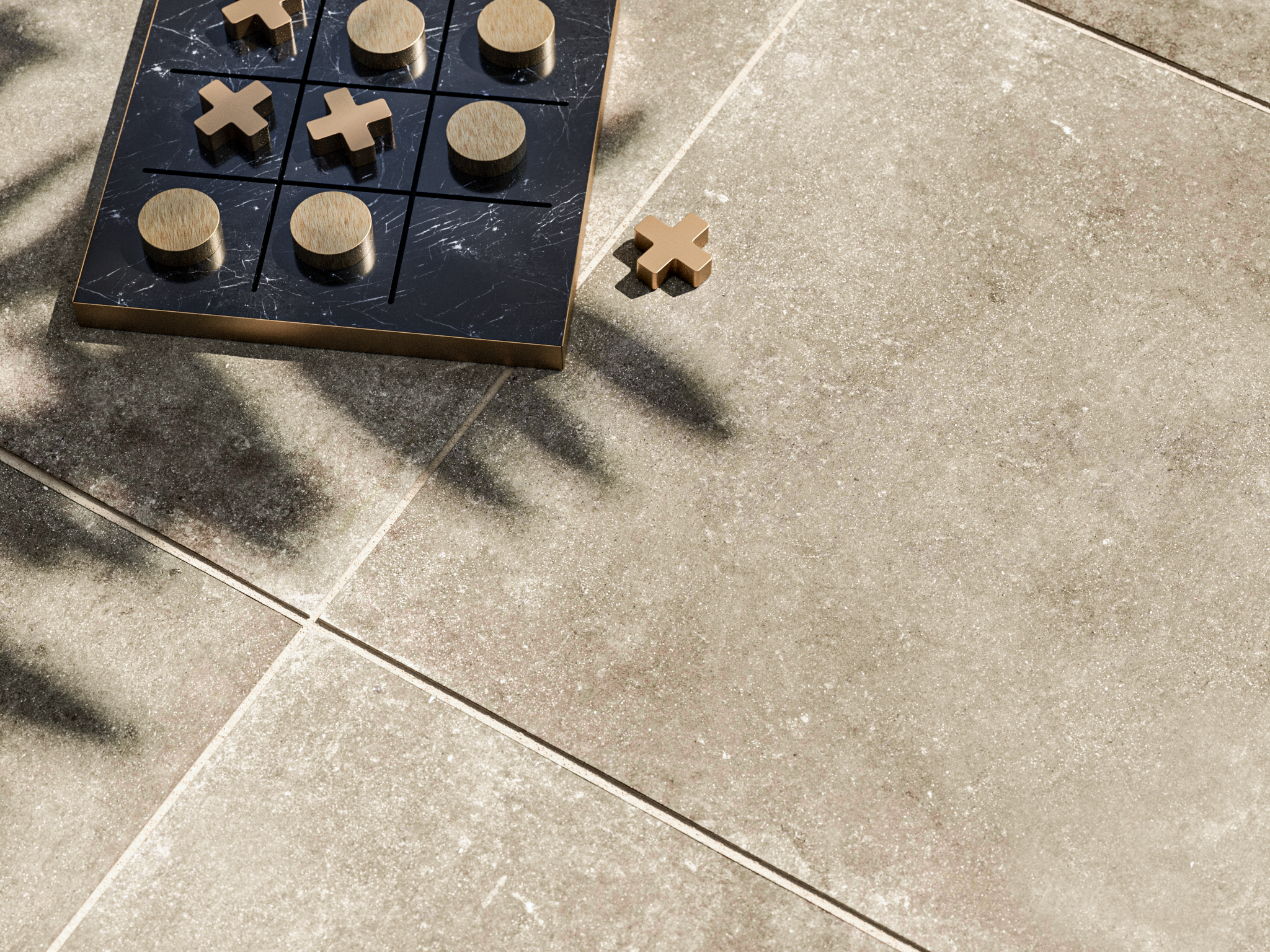 Gros plan sur le dallage imitation béton Roma, avec un jeu en bois et une ombre