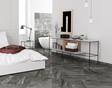  Une chambre dans laquelle a été posé un carrelage en grès cérame effet granite Dolomit Black.